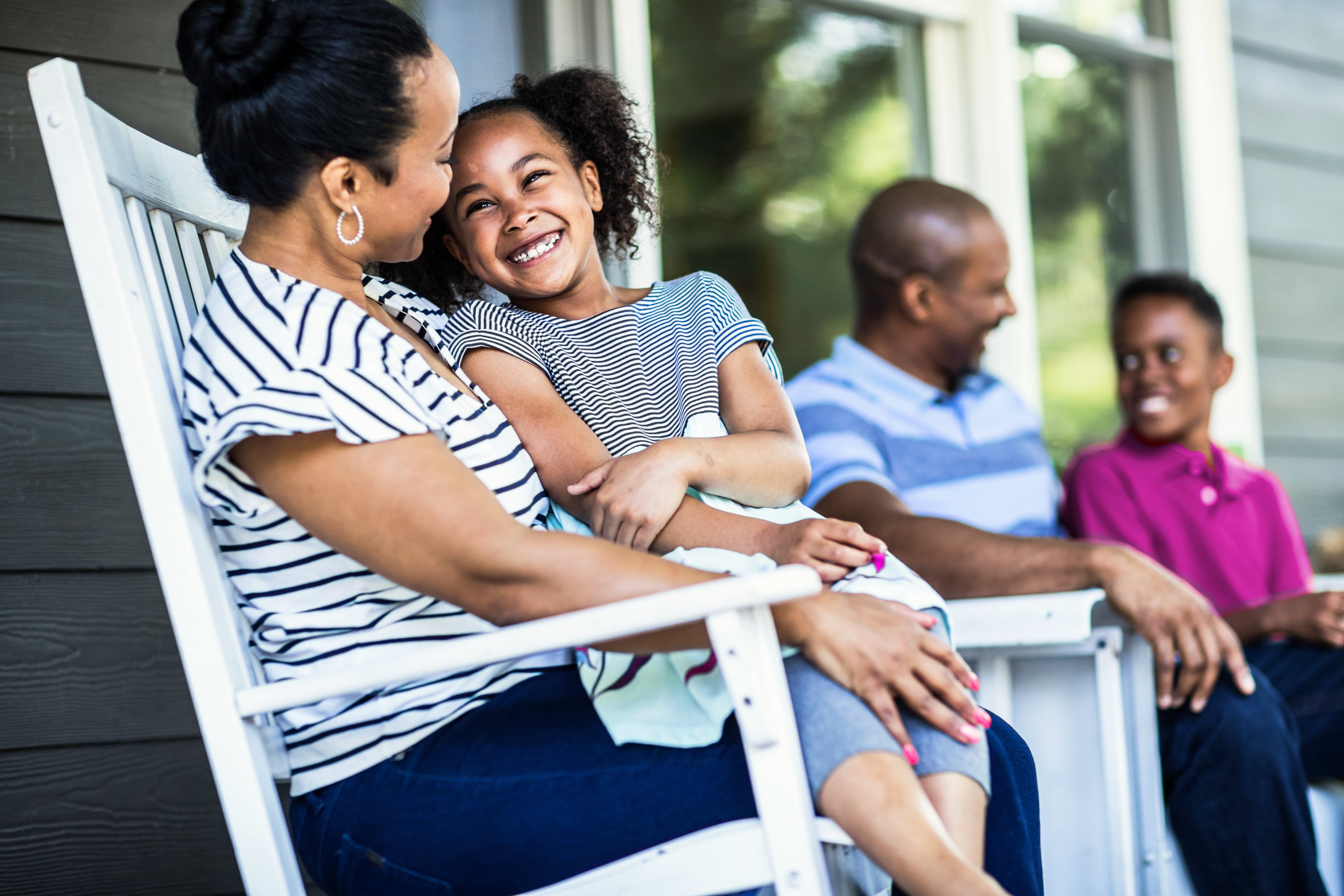 Family laughing on front porch